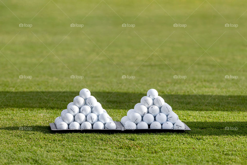 Tennis balls on green grass ready for a practice