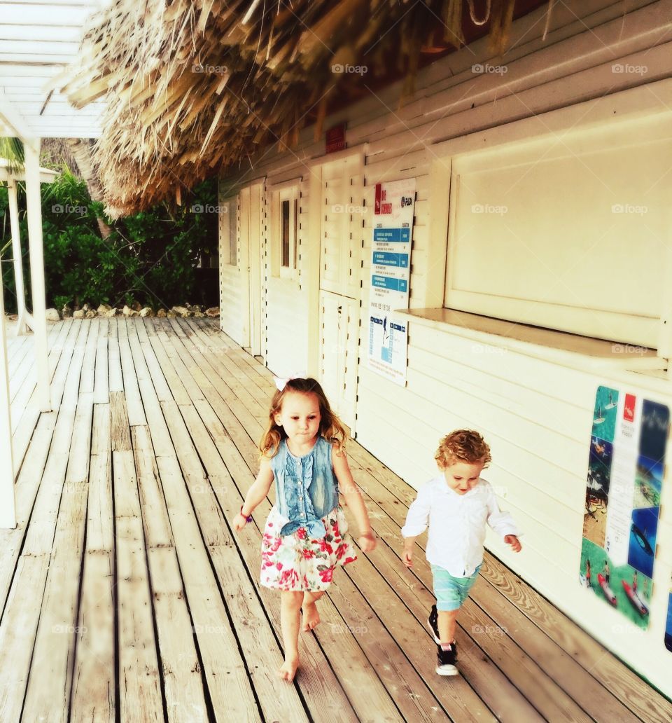 Boy and a girl toddler walking 
