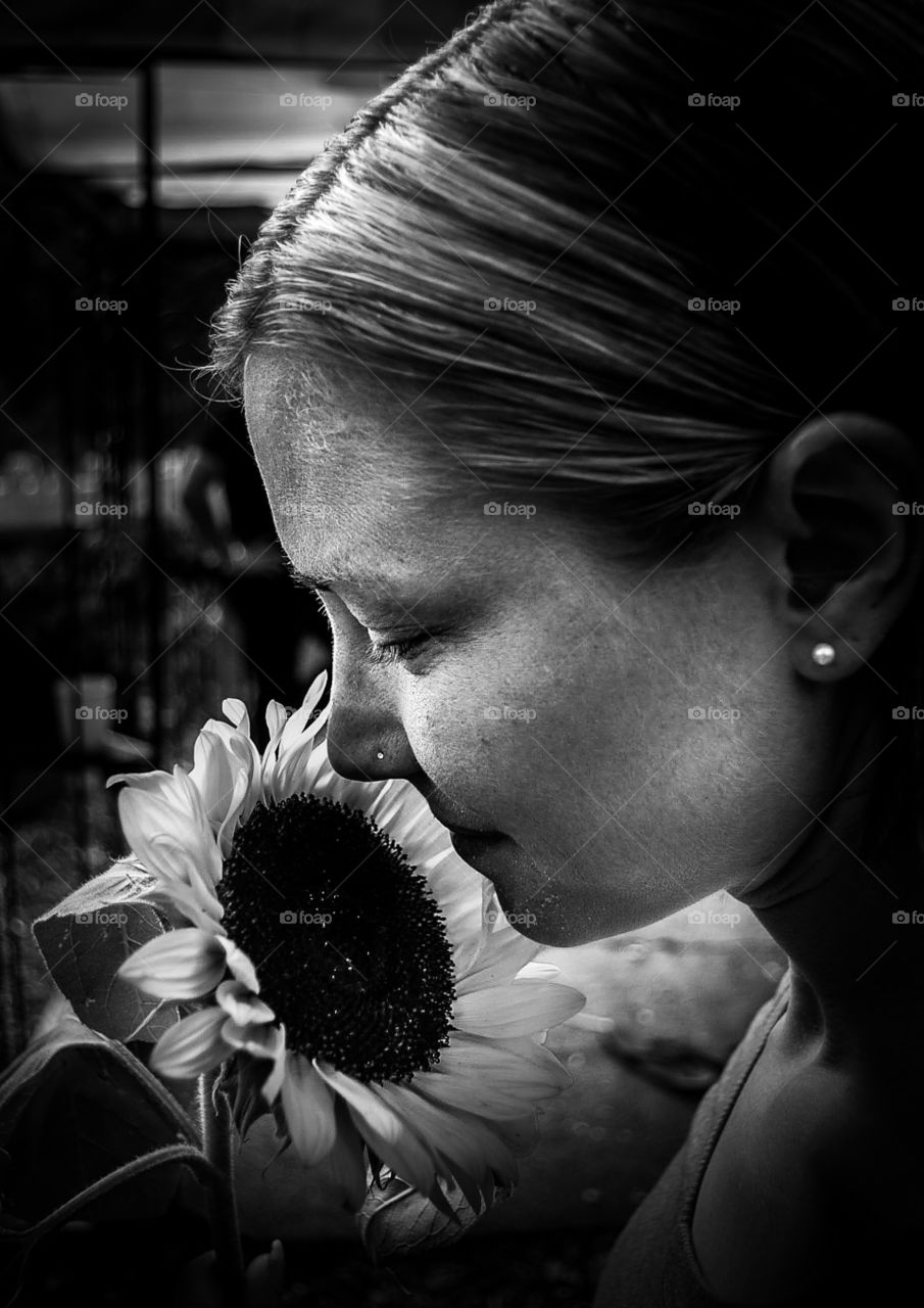 Woman smelling Sunflower