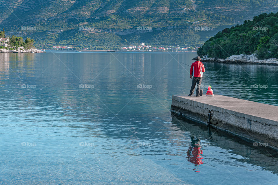 Fisherman standing on the pier