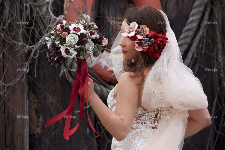 bride looks at flowers