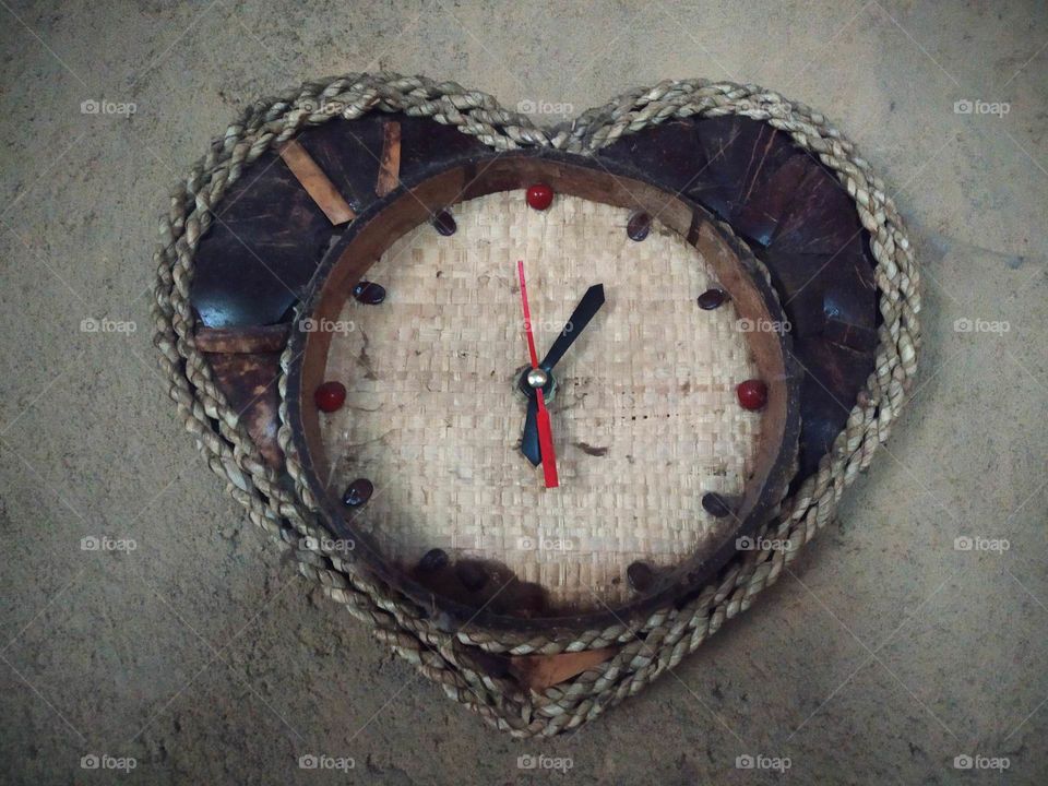 this wall clock is made from dried coconut shell.  coconut shell processed and shaped as jewelry on the watch . home made