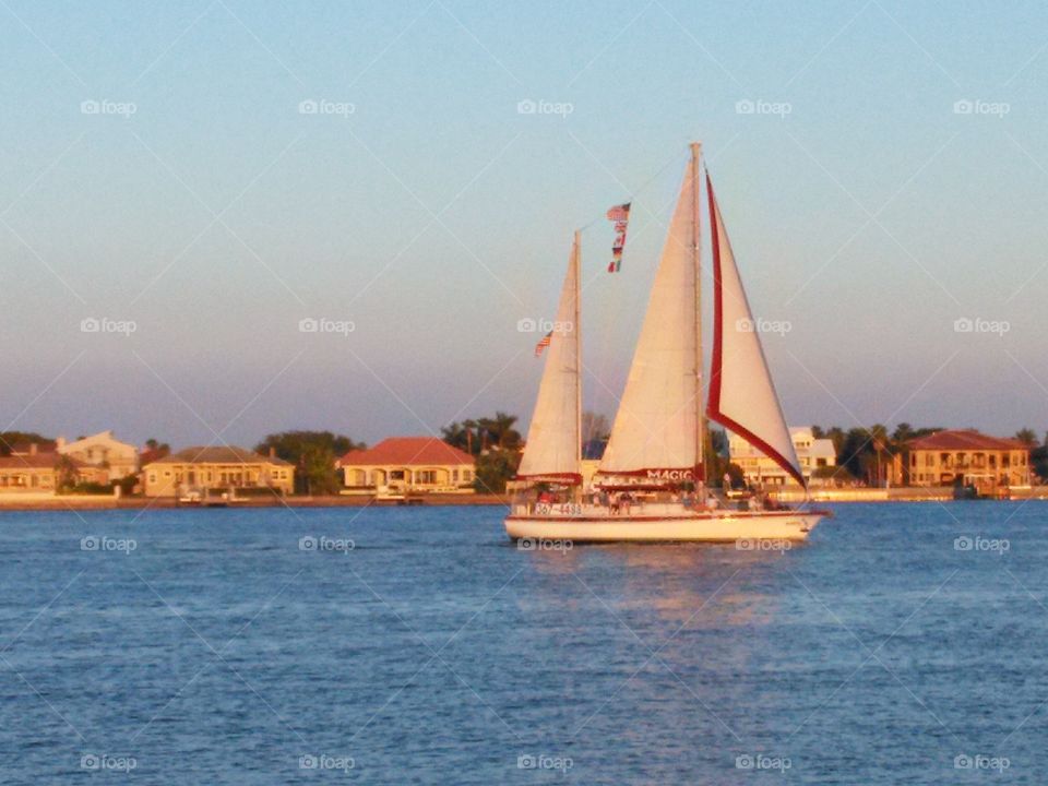 Sunset Cruise. Sail boat leaving Pass-a-Grille, FL