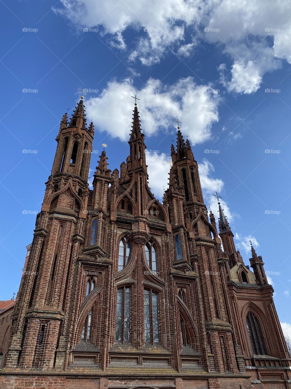 St. Annes Church in Vilnius, Lithuania. A gothic church of red bricks. Blue sky with some white clouds.
