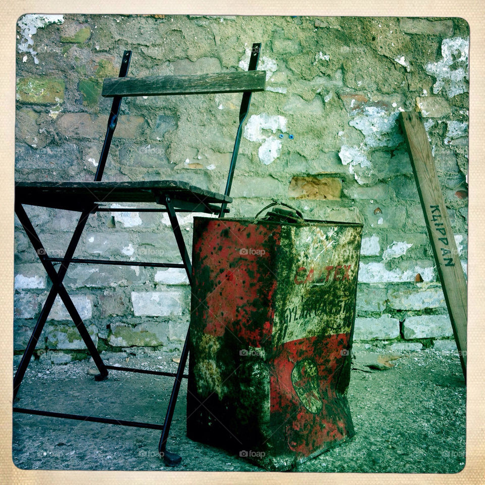 Rusty can and old chair