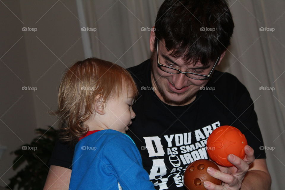 Daddy and son bonding over a game of ball throwing