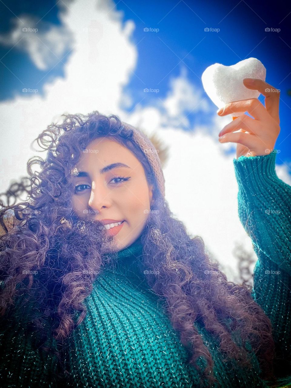 Curly-haired girl with a snowy heart