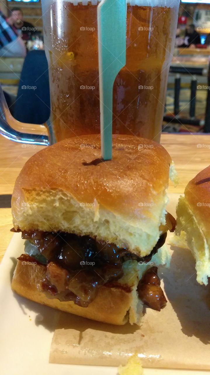 mini burger and a tall glass of beer