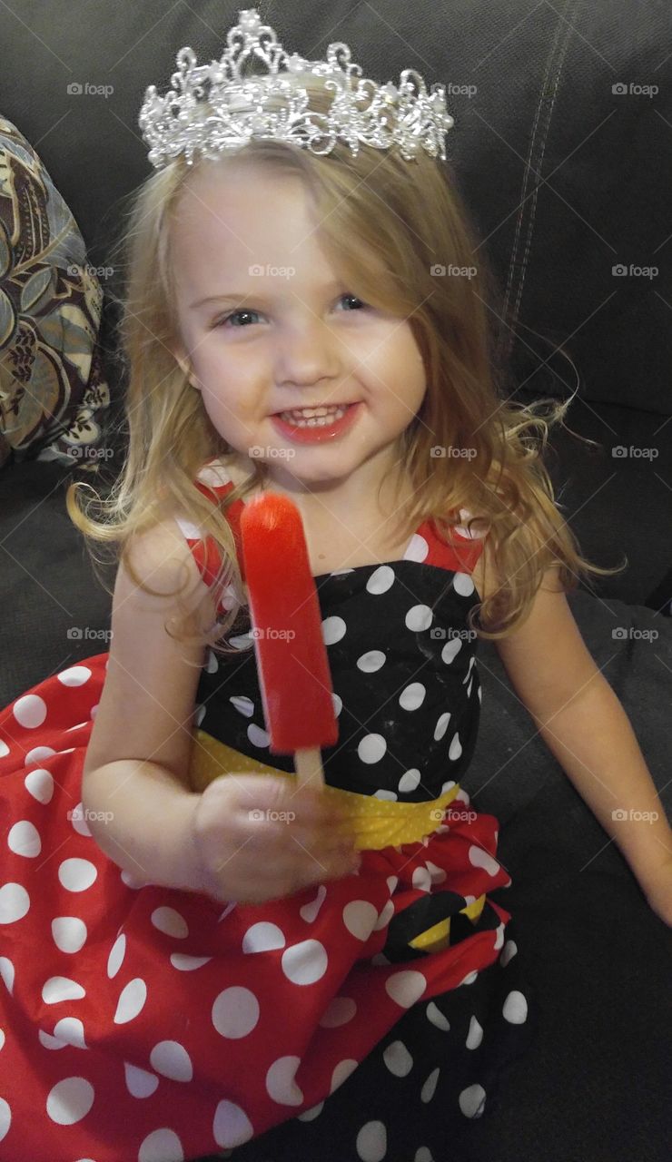 Beautiful girl eating a popsicle.