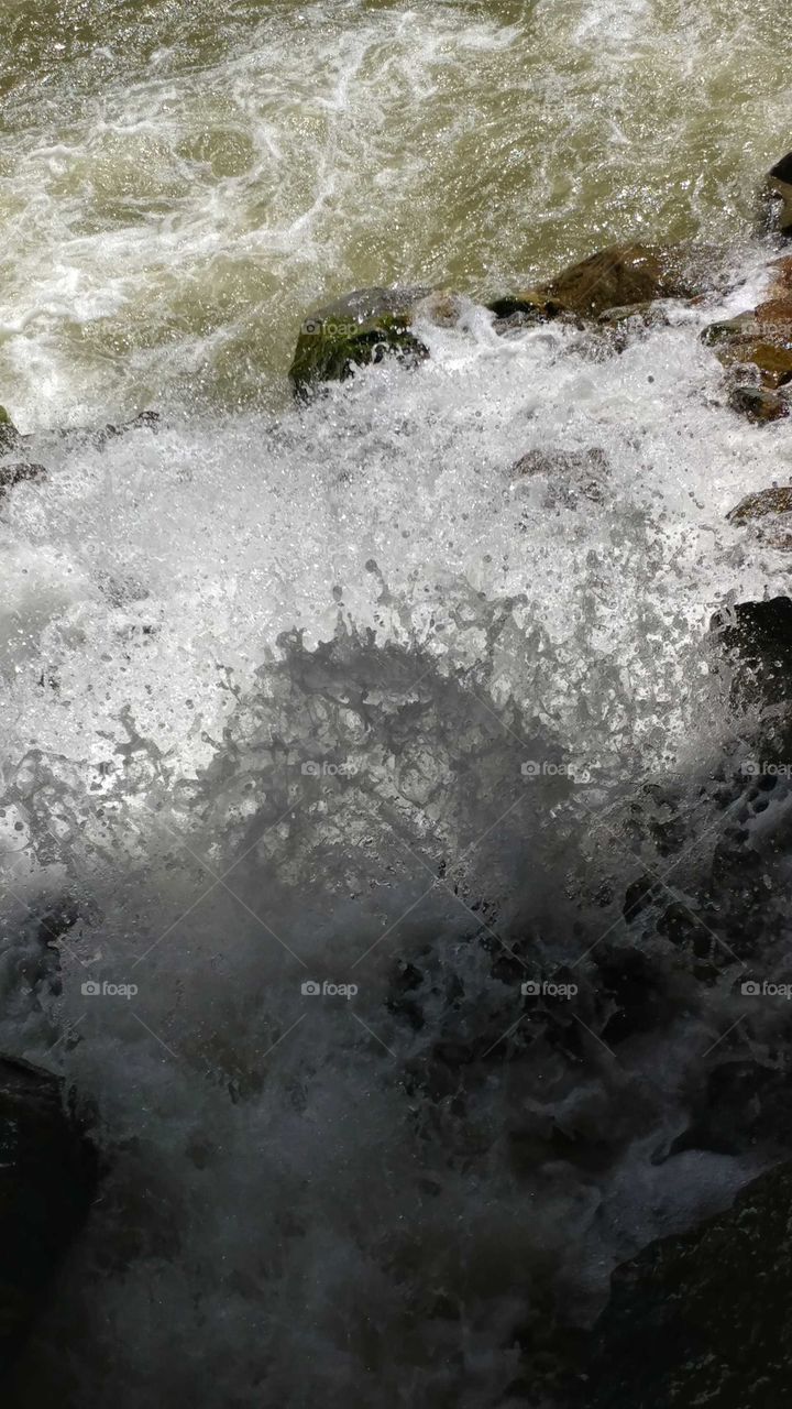 A chaos of waterfall and rapids colliding to rush down the boulder strewn canyon.