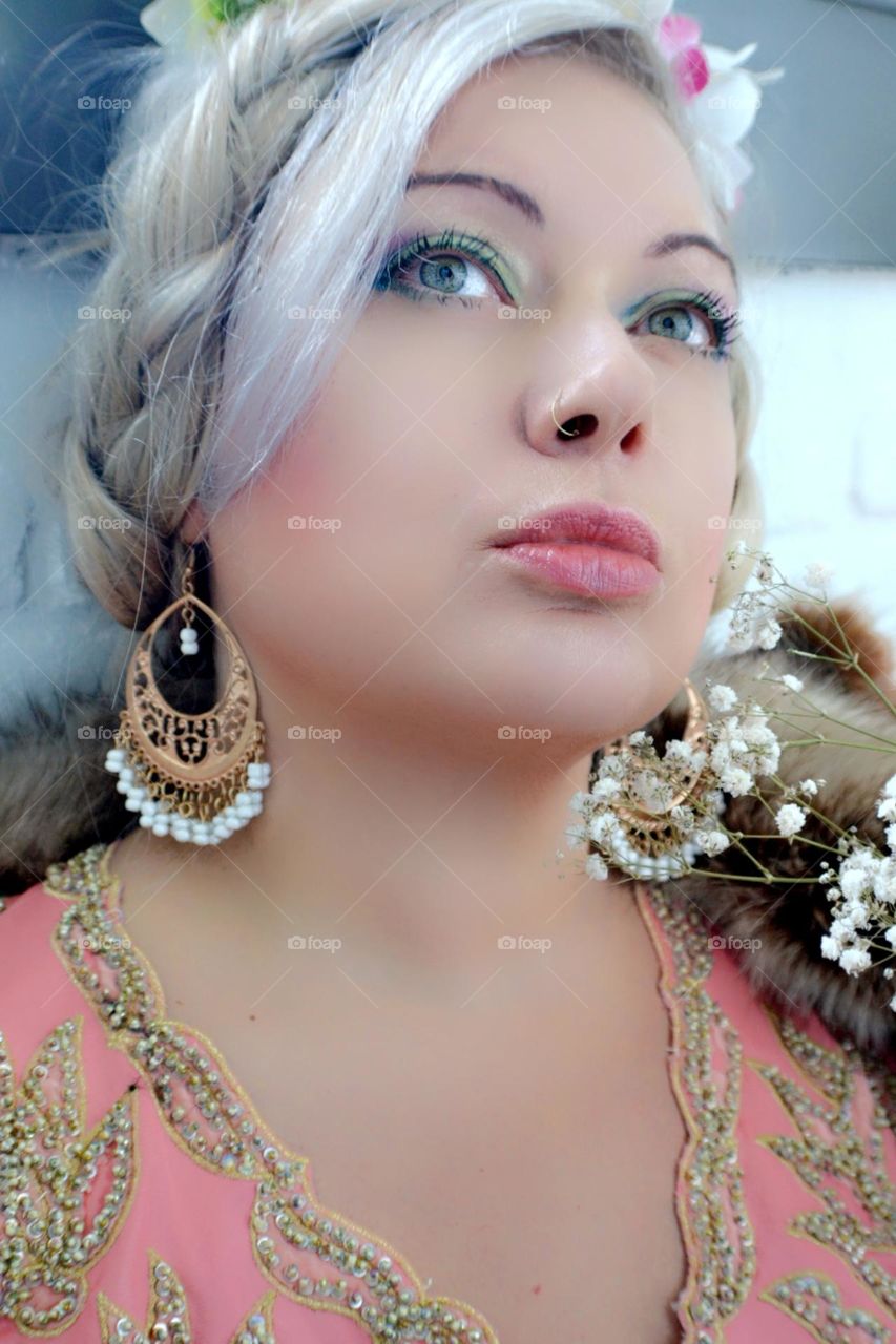 Beautiful portrait of a woman wearing crown flowers festive clothing