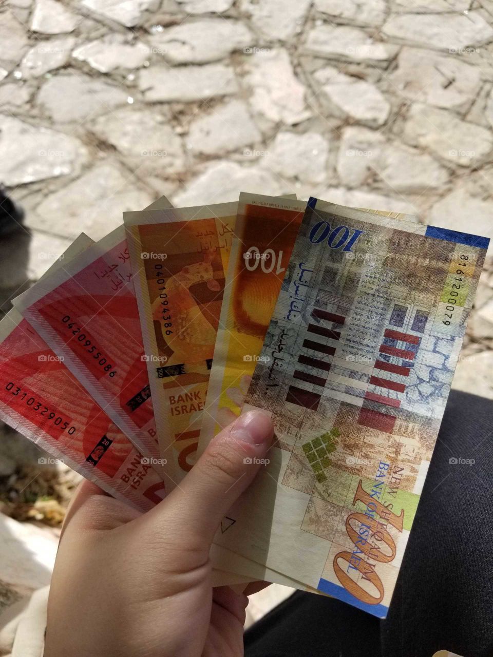 These are Israeli Shekels. They are different colors, these ones are red, orange, and blue notes. This would amount to 340 Shekels.