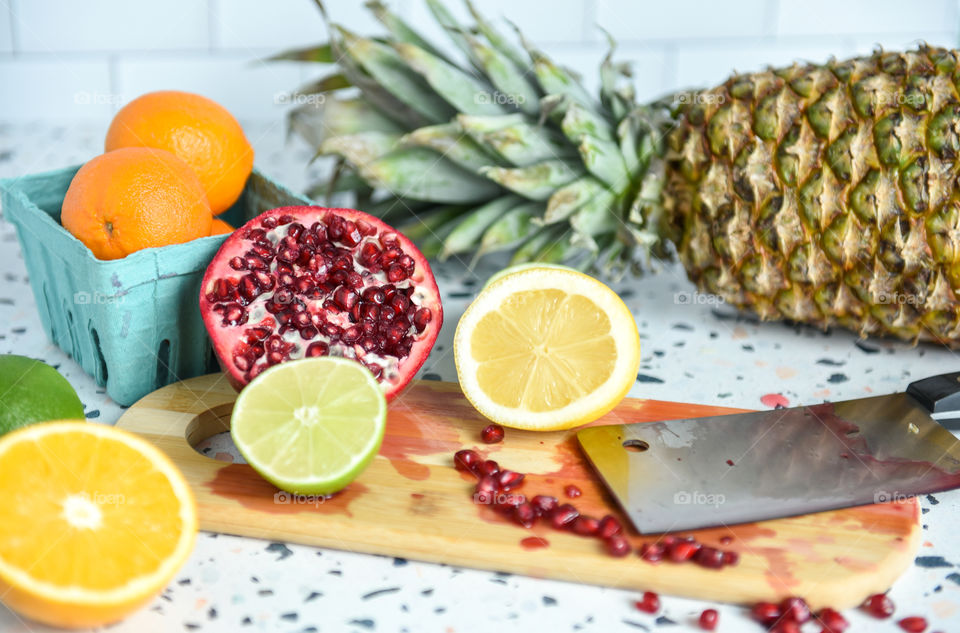 Close-up of fruit being cut on a cutting board 