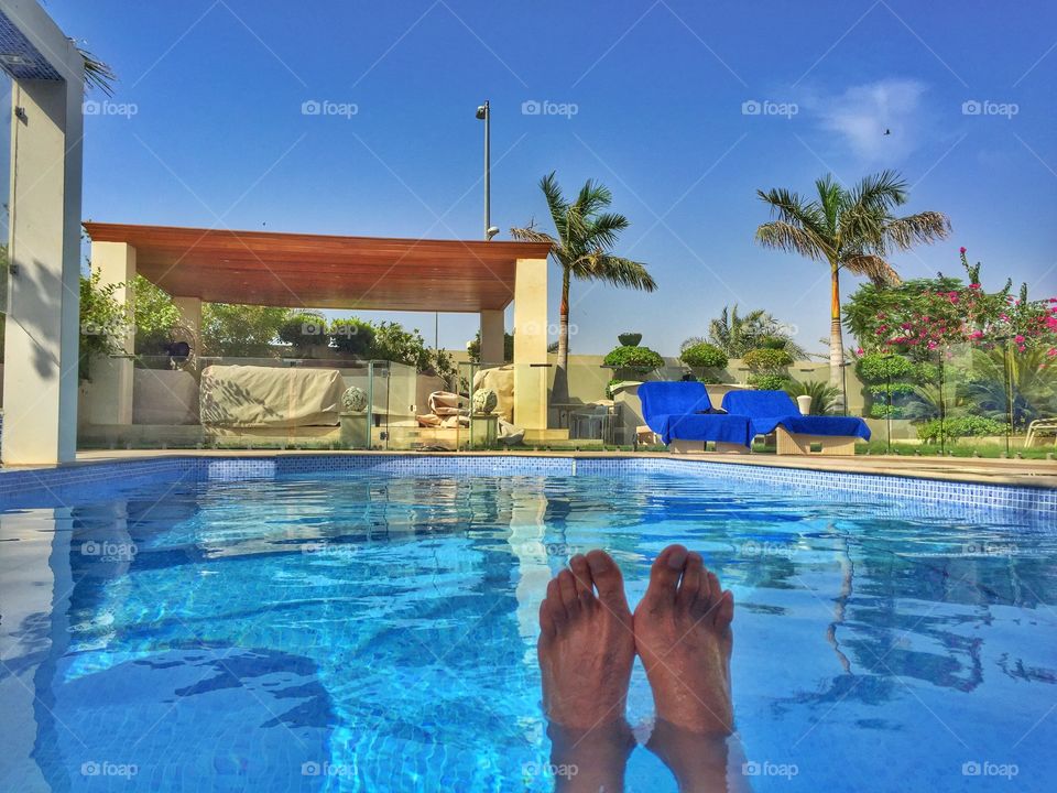 Feet up. Chilling in the pool