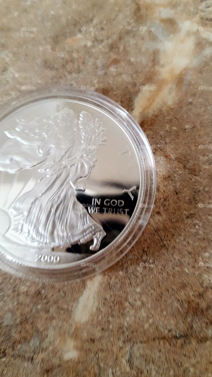 silver coin in GOD we trust