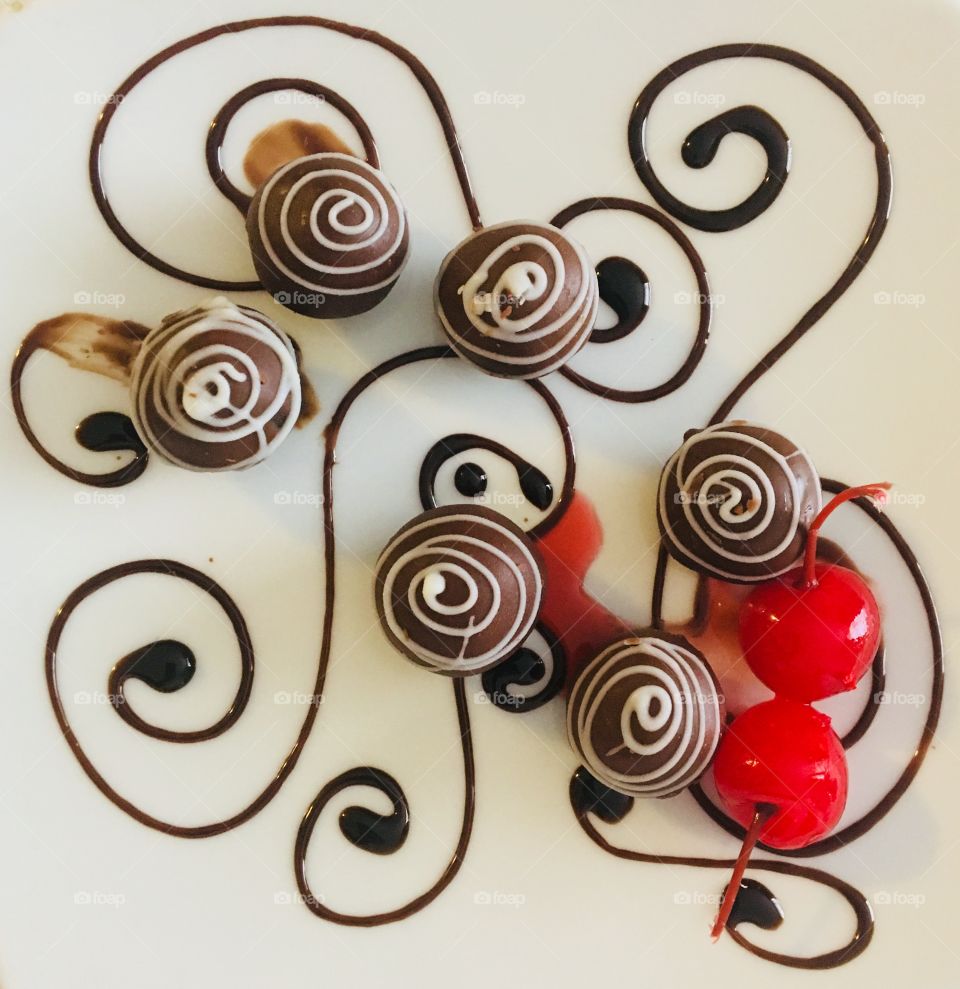 Chocolate candies with cherry and chocolate syrup