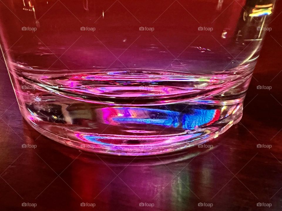 A lone glass on a night out captures the colors around us
