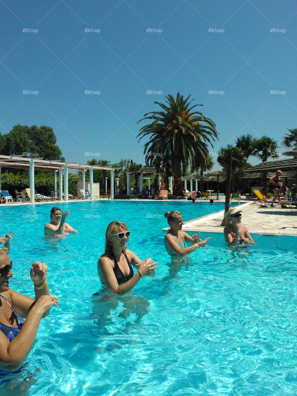 Group of women posing in swimming pool