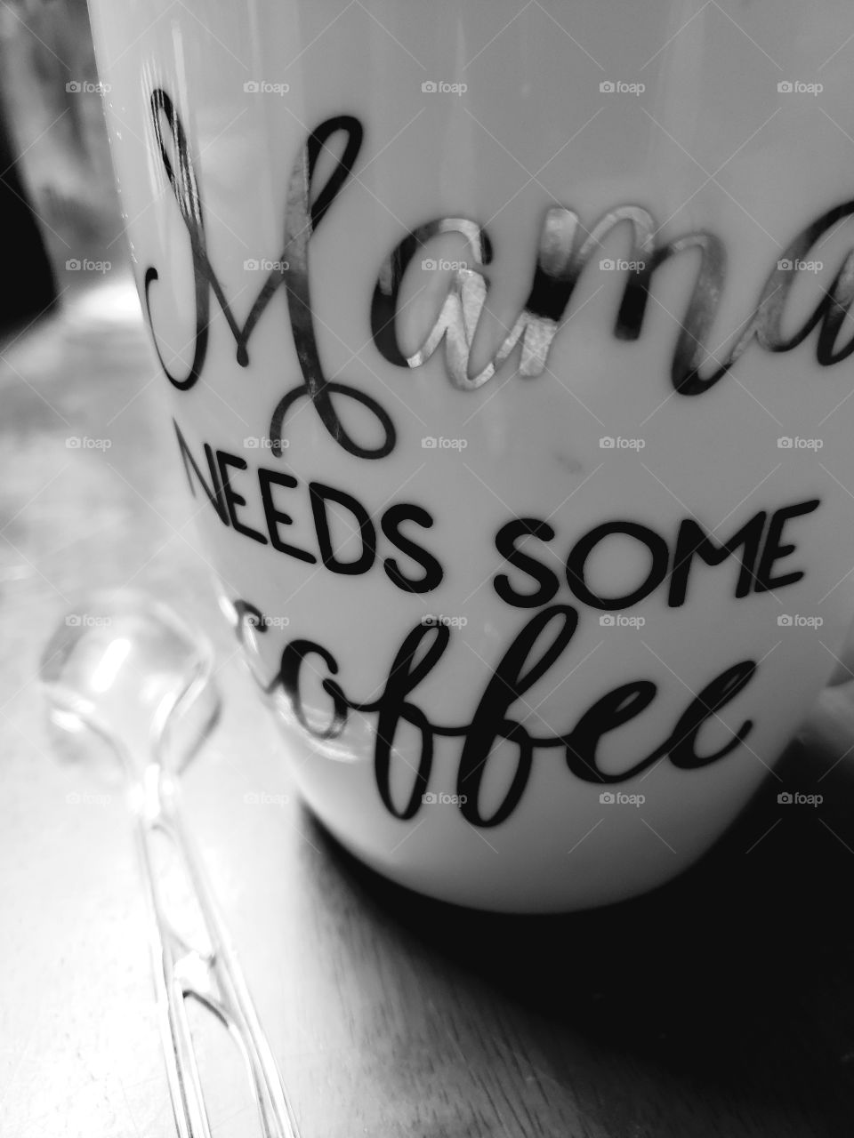 Black and white photo of an oversized coffee mug that says MAMA NEEDS SOME COFFEE (don't we all?)