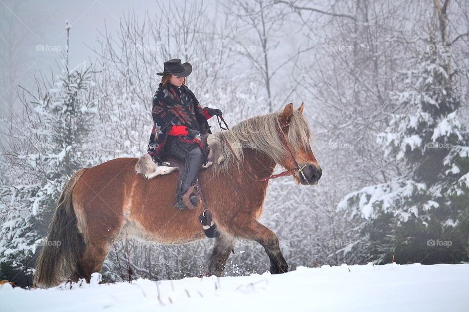 Girl riding her horse