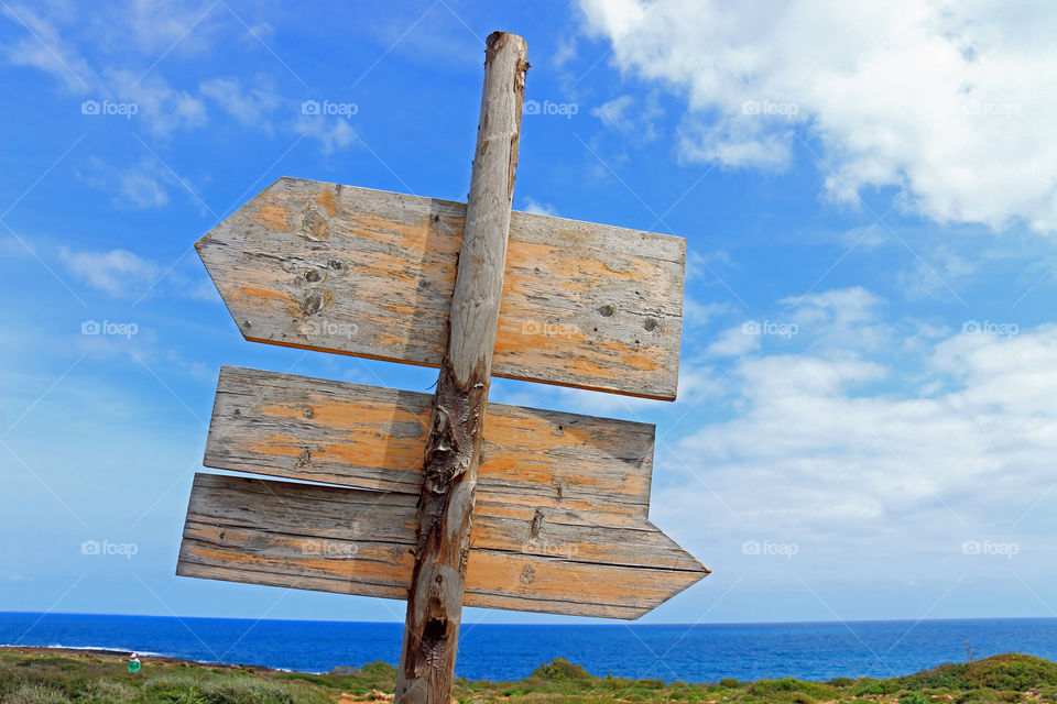 Blank wooden placard on beach