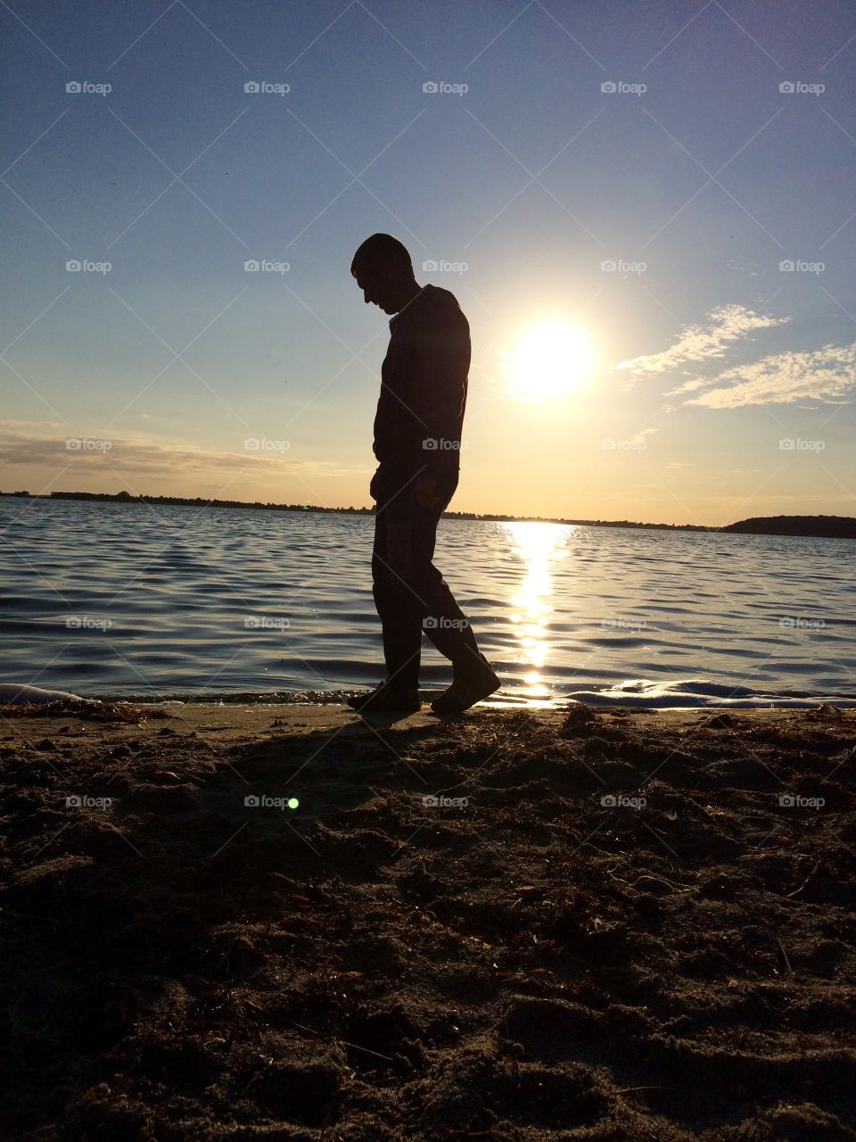 Silhouette of man walking on beach