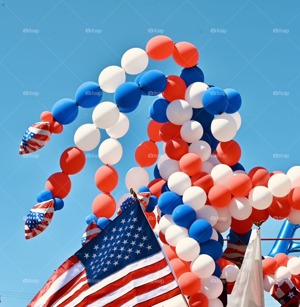 Flags and balloons during the annual parade of the 4th of July in Modesto, California. 