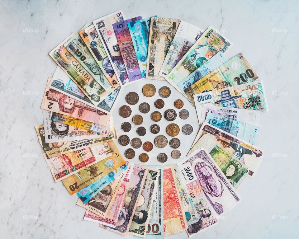 International Money Photo

 Money from all over the world is laid out in a circle surrounding the coin.