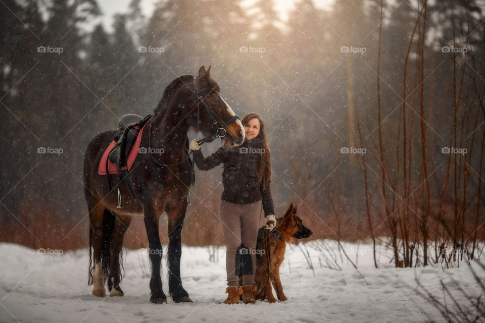 Beautiful young woman with horse with German shepherd dog outdoor portrait at spring day