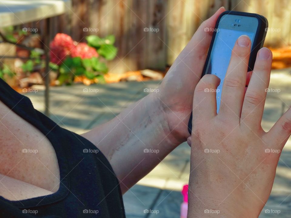 Hands Texting On A Smartphone
