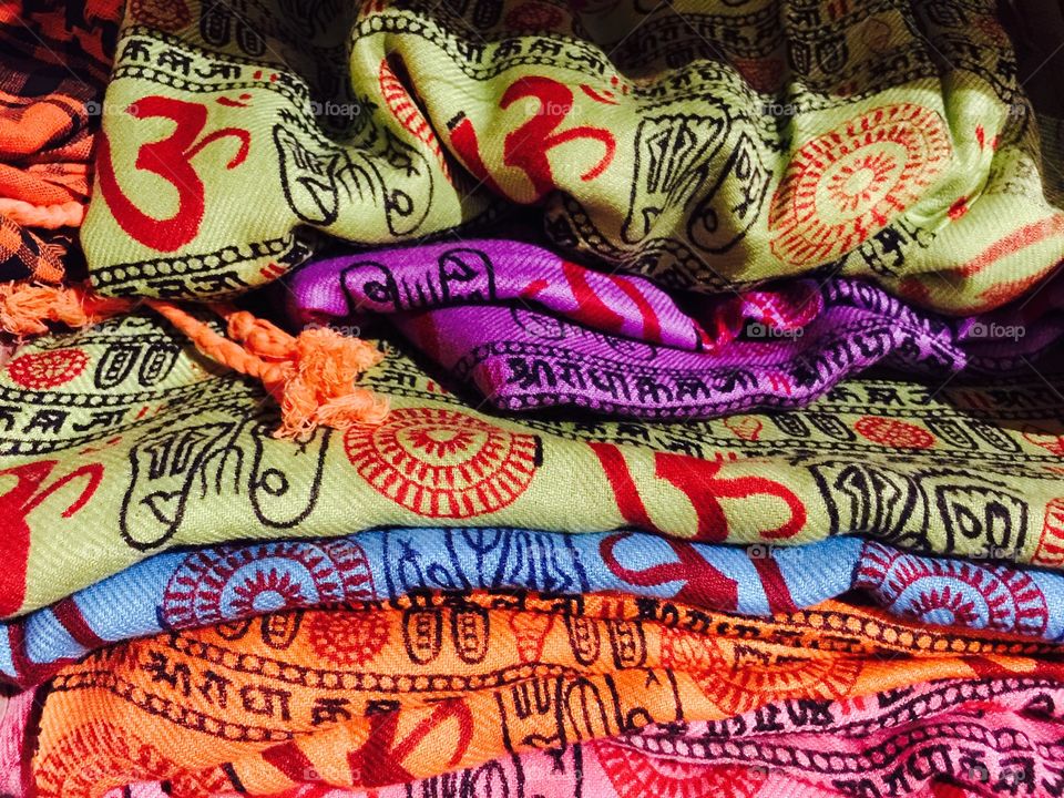 Colorful Ohm . Different color clothes with spiritual Indian symbols.