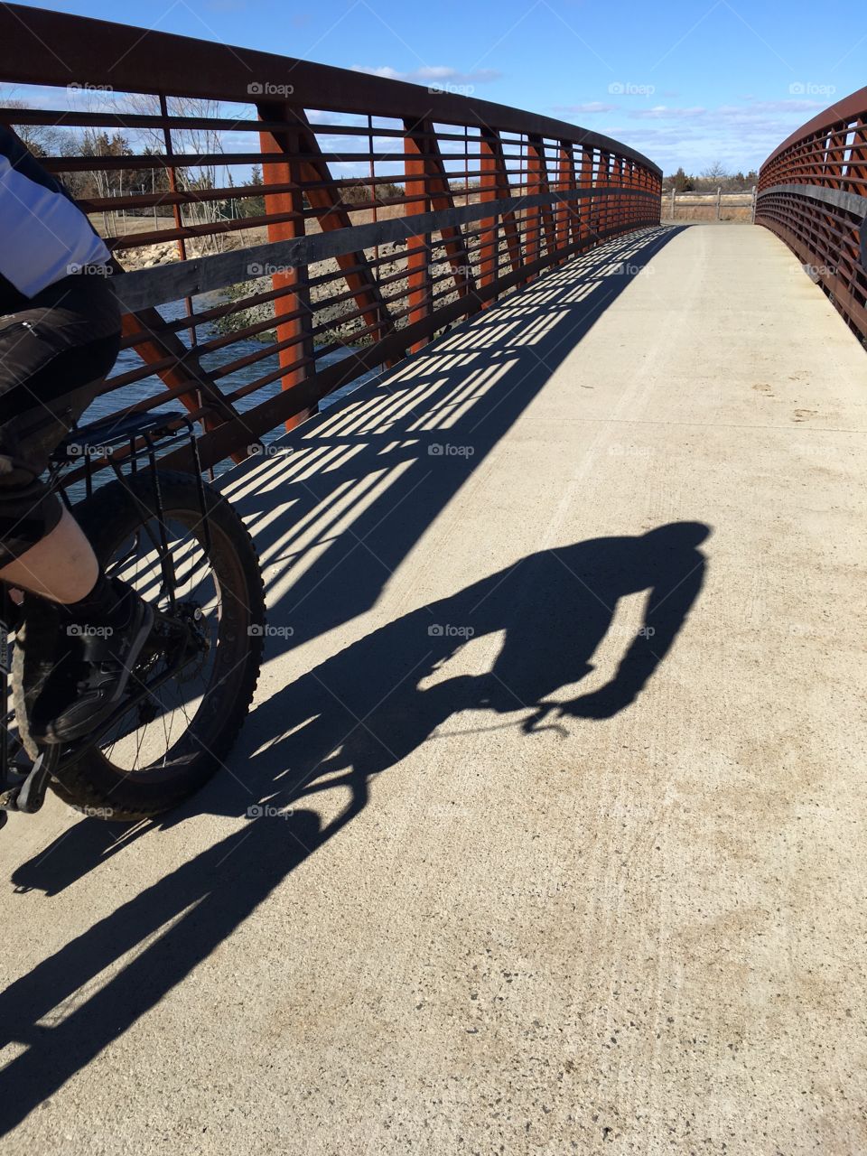 Playing with light. A bicyclist's shadow while riding.