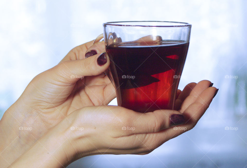 A person holding a cup of tea