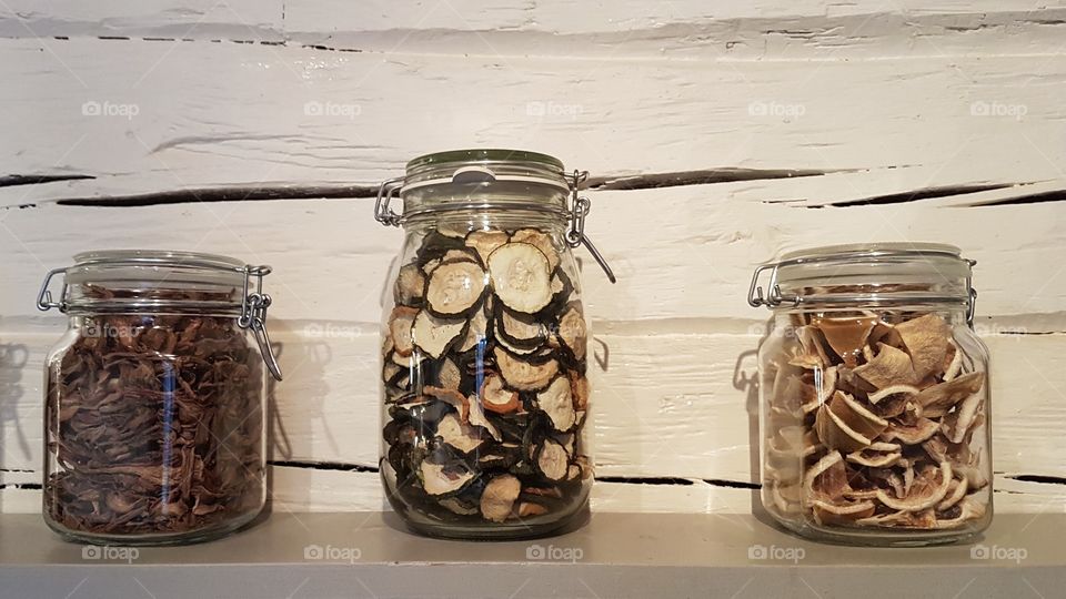 Dehydrated vegetables and mushrooms in glass jars 