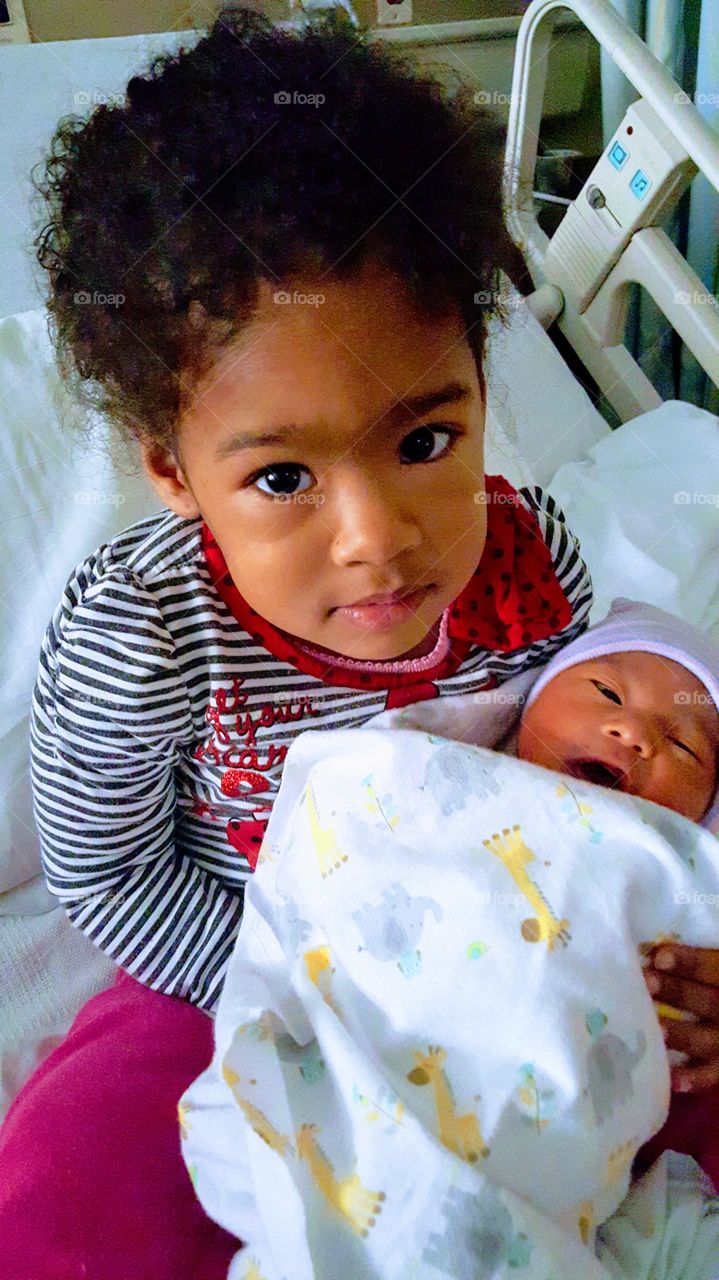 A big sister welcoming her newborn baby brother into the world...They are my grandchildren