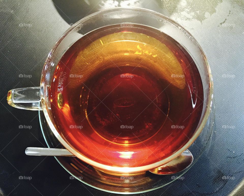 Cup of black tea from above, transparent cup, round shape 