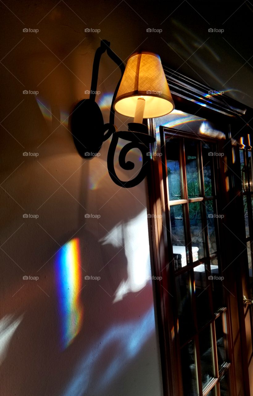 Light fixture with shadows and prism rainbow