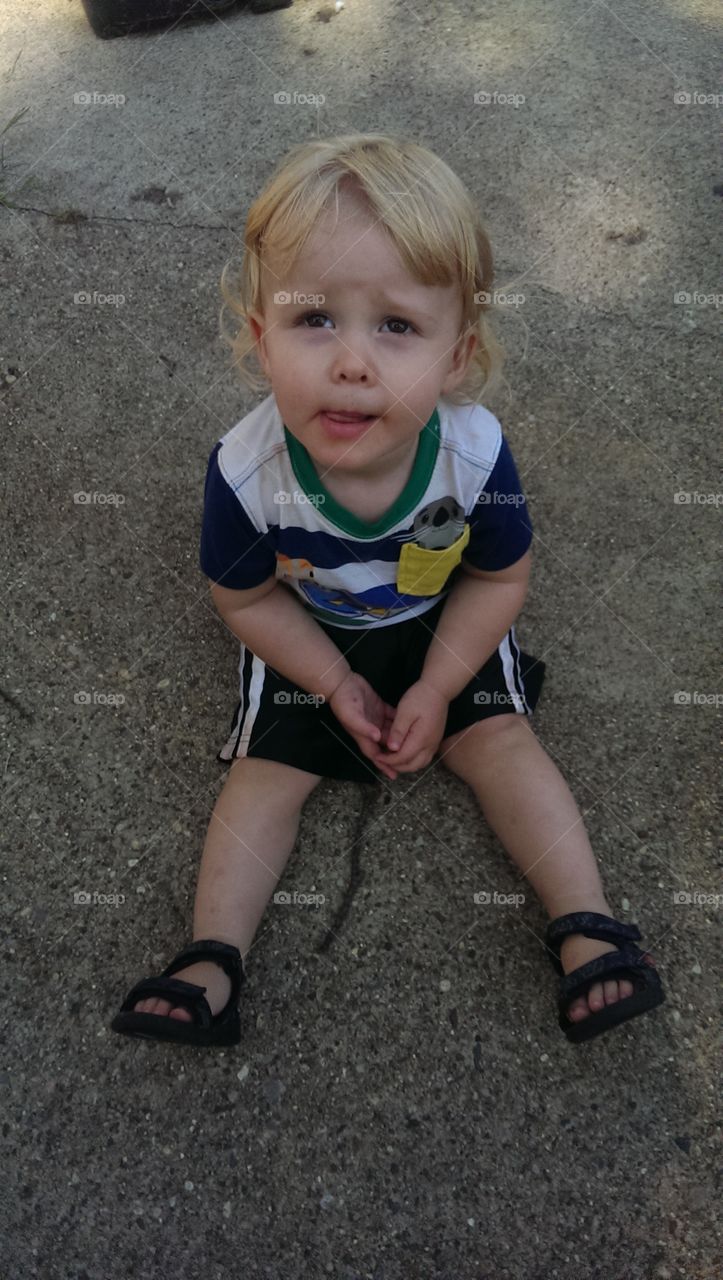 toddler boy looking up outside