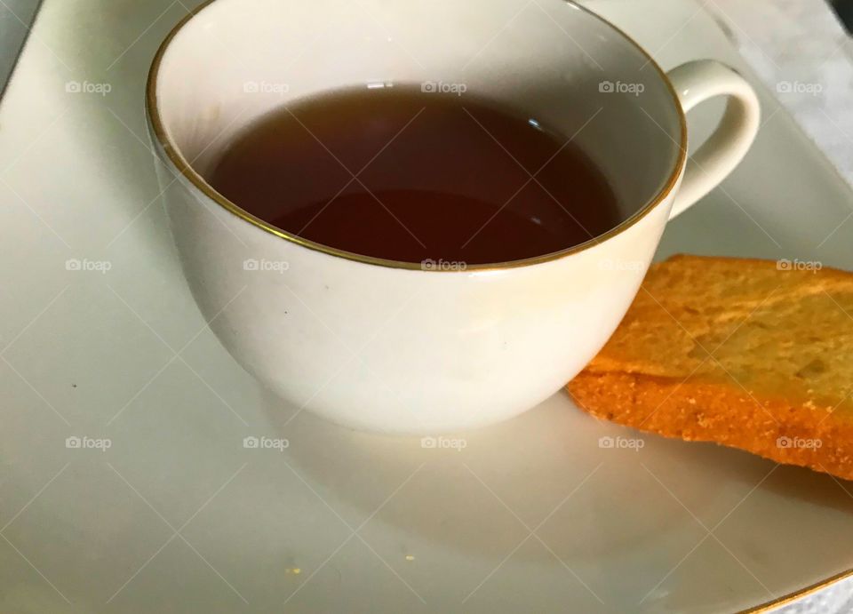 Hot tea and biscuits on plate breakfast snack food 