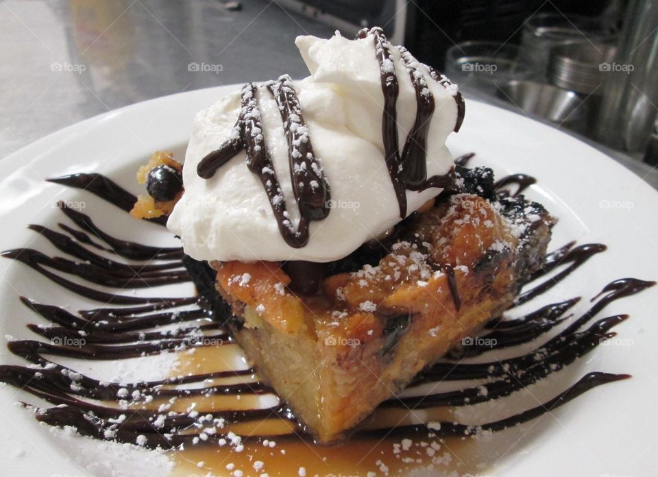 Chocolate peanut butter bread pudding with fresh whipped cream and caramel sauce