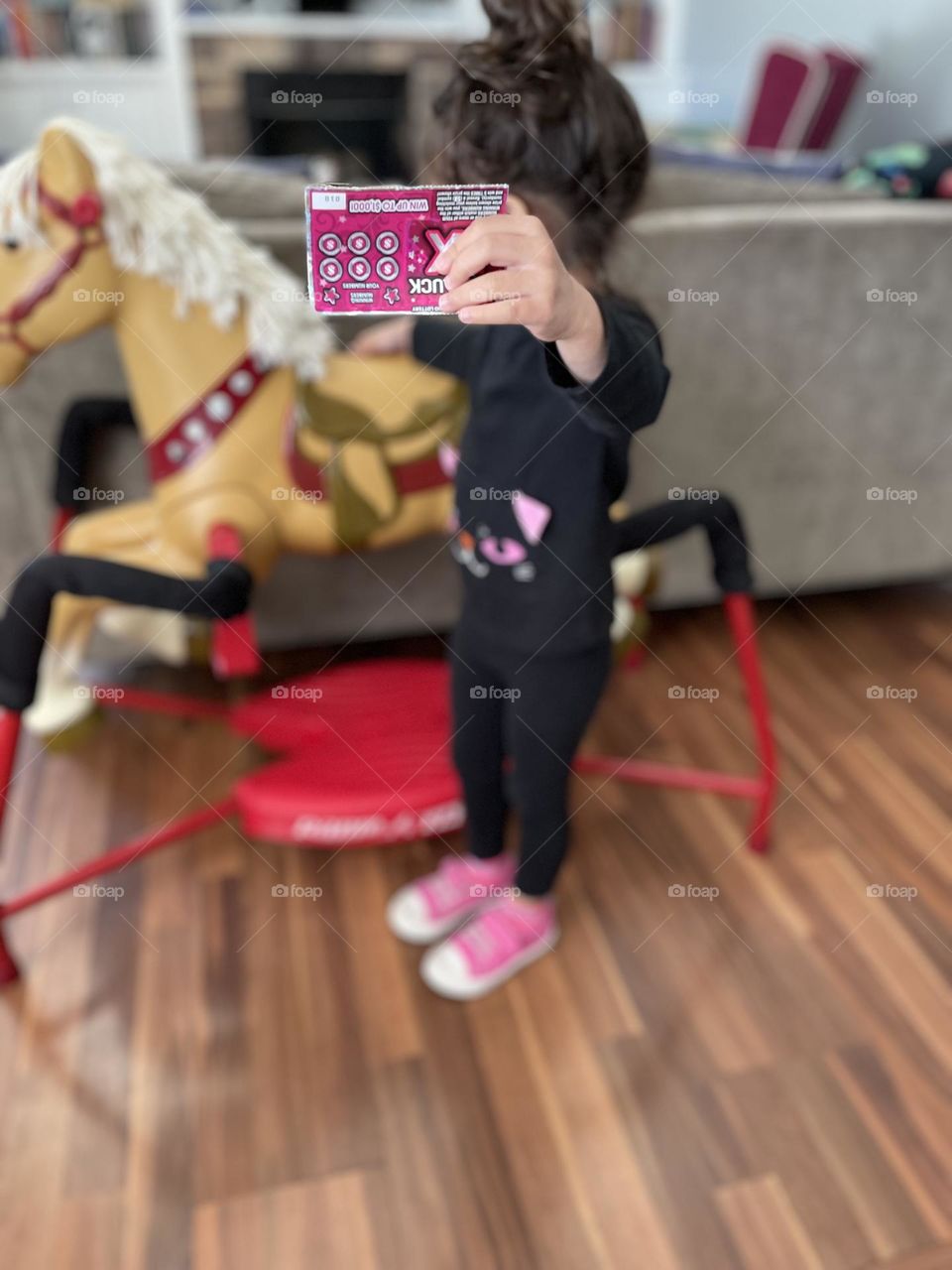 Child holding scratch off lottery ticket, toddler being silly with lottery ticket, funny child with lottery ticket, Lady Luck 