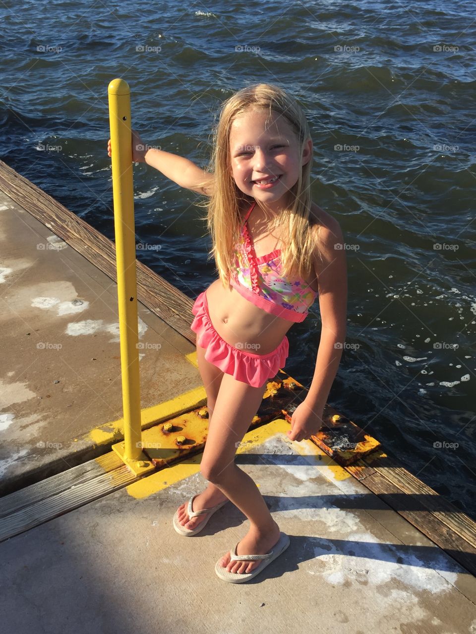 Little girl on a boat dock