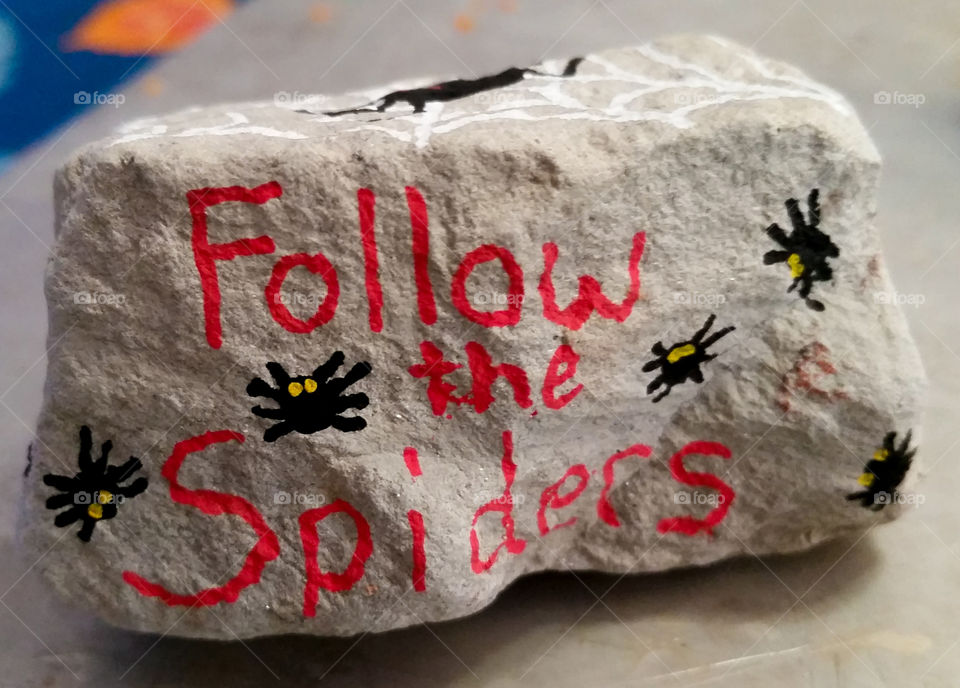 Follow the Spiders a hand painted rock for Halloween