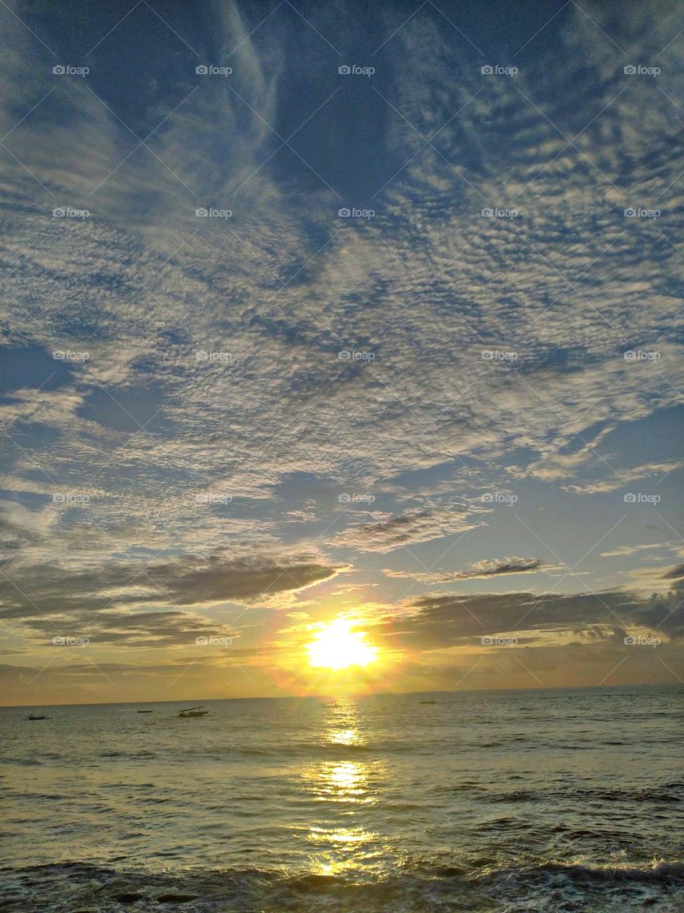 the morning sun at Sukasada Karangasem Bali beach, with a clear sky