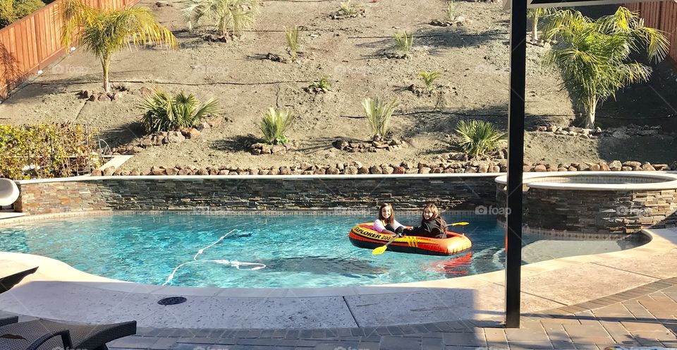 My girls in a boat on our pool