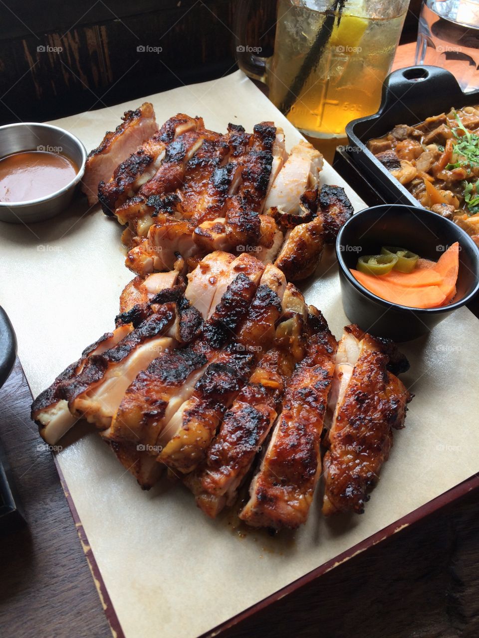 Smoked chicken . Delicious BBQ smoked chicken on a wooden plate