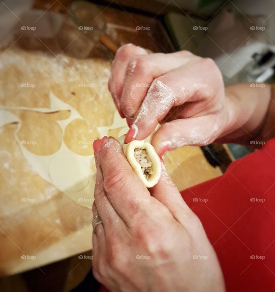 A person making pierogi