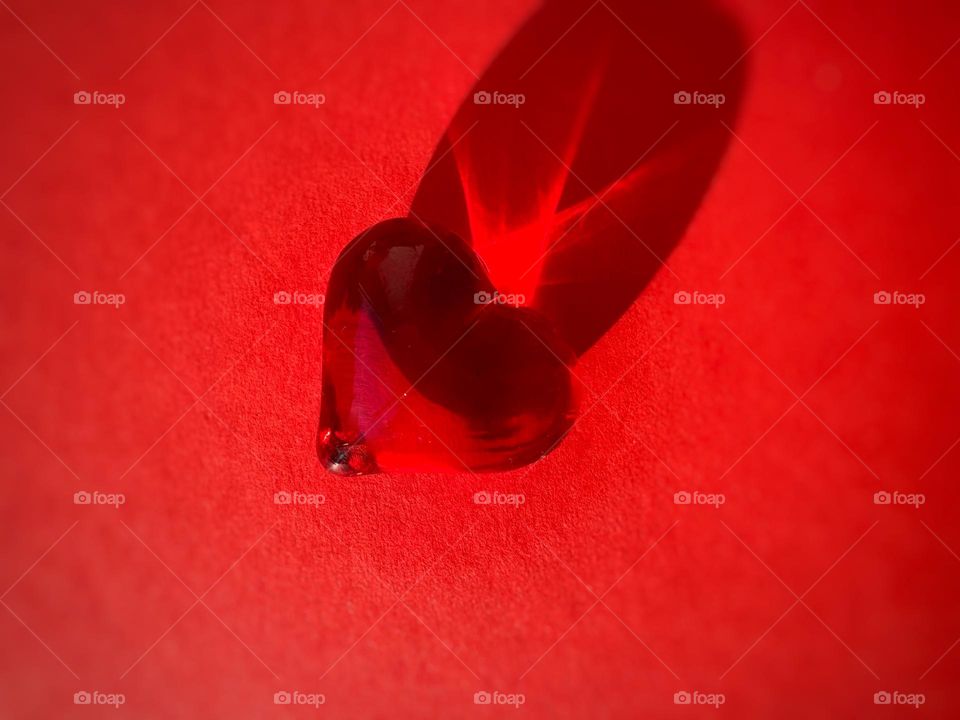 Red heart on the red background 