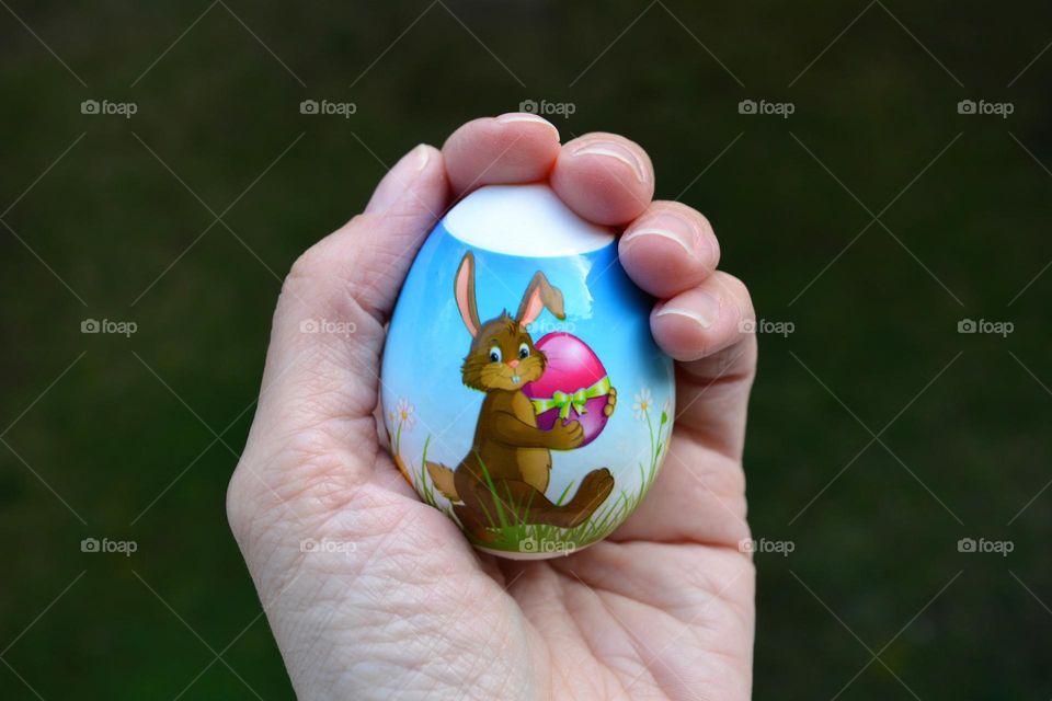 Easter egg in the hand spring holiday