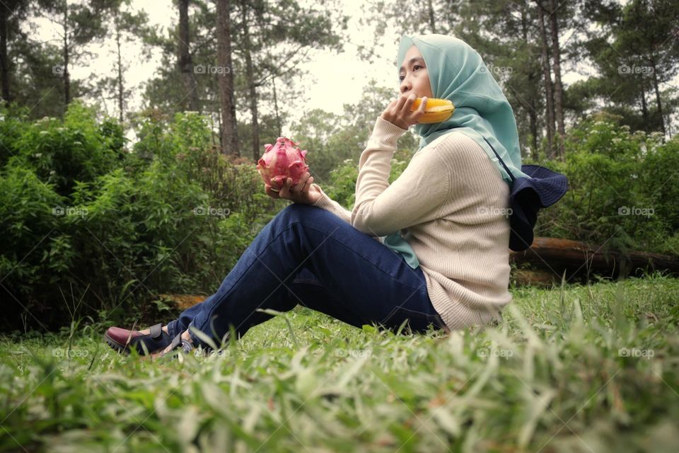 full length of woman sitting on field